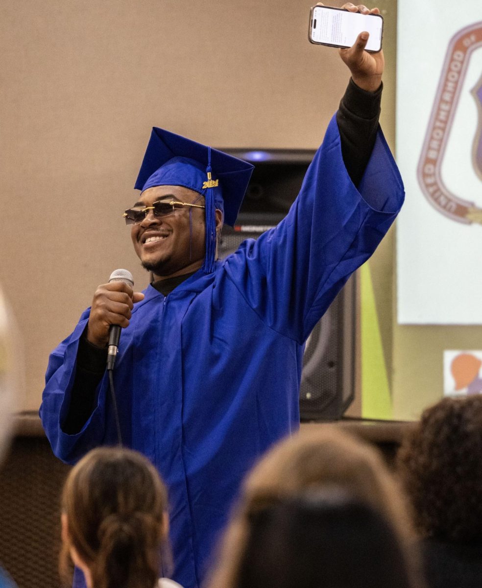 LaTaveon Gibbs-Caves raises a triumphant hand while giving his graduation speech at the Carterville Community Center Thursday, Nov. 14.
