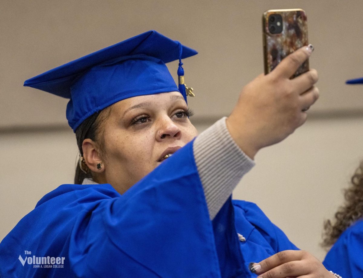 Bertha (BeBe) Reed documents her graduation ceremony Nov. 14 at the Carterville Community Center.