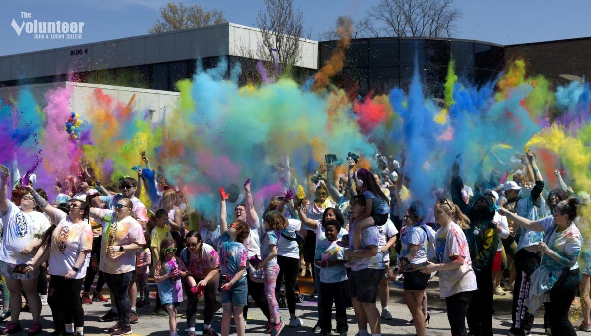 Participants launch a burst of color to close out the Autism Color Run at John A. Logan College on Saturday, April 12. The event raised funds for the Autism Society of Southern Illinois and featured food trucks, games, and community volunteers.