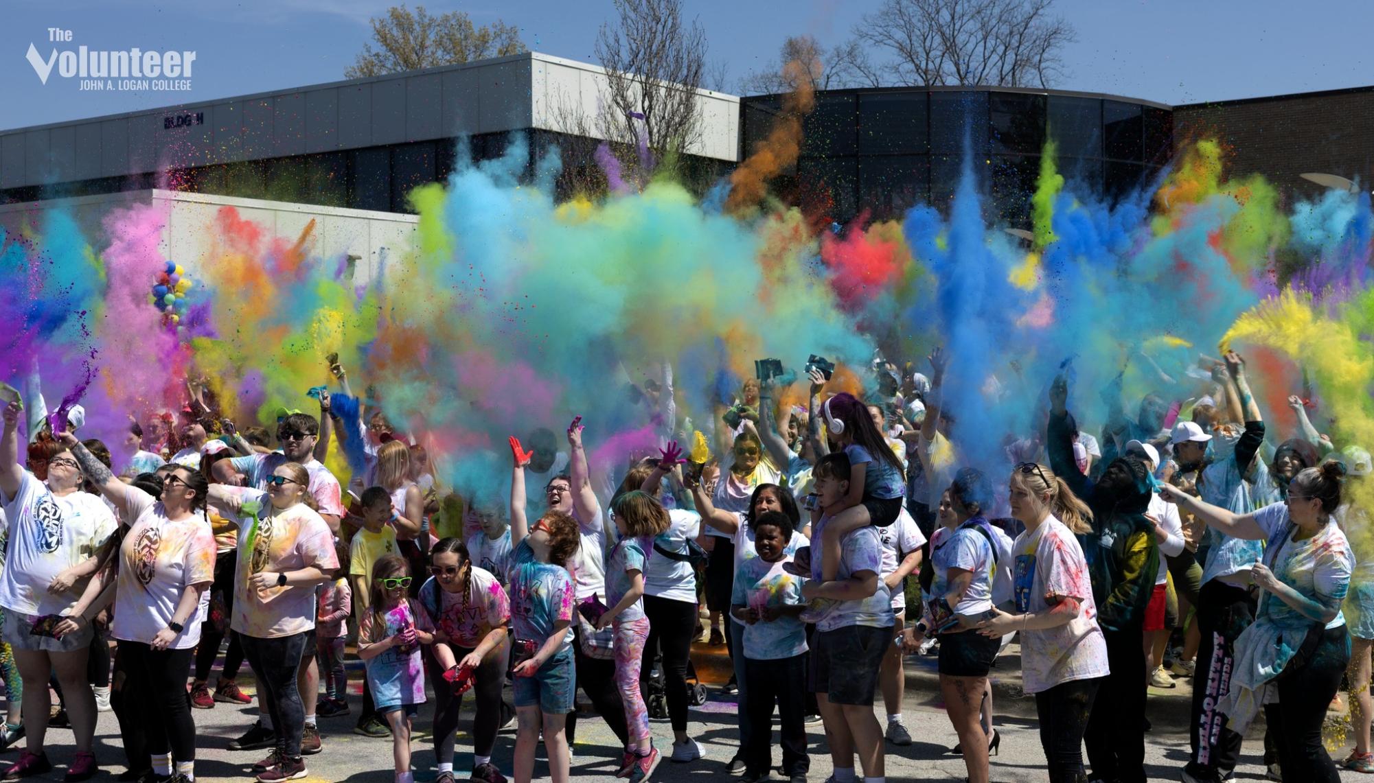 Participants launch a burst of color to close out the Autism Color Run at John A. Logan College on Saturday, April 12. The event raised funds for the Autism Society of Southern Illinois and featured food trucks, games, and community volunteers.