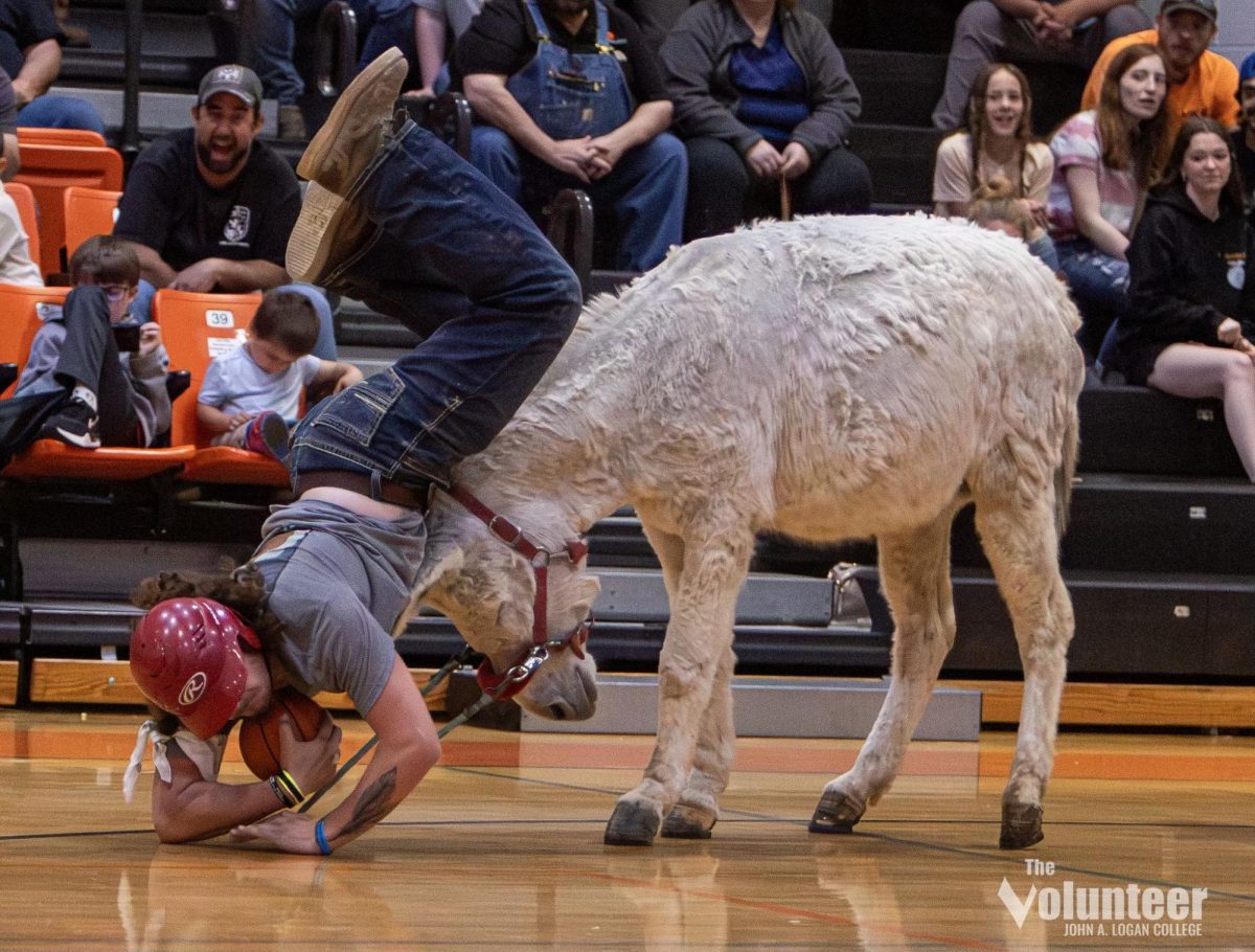 Tanner Bailey takes a spill after his donkey starts bucking during the Crab Orchard FFA Alumni’s donkey basketball game.