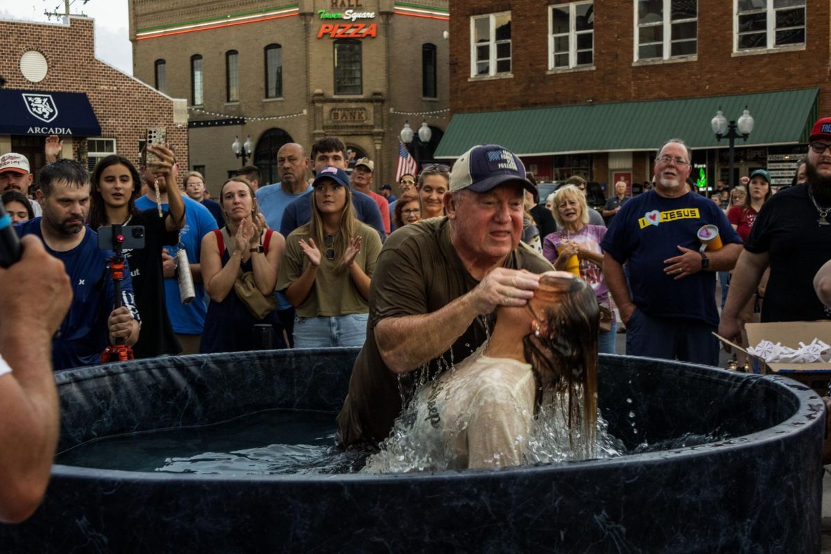 In the aftermath of the assassination of Charlie Kirk, a conservative political activist, Redemption Church hosted a memorial service at Tower Square in Marion on Sept. 14 at 5 p.m.
An estimated crowd of more than 1,000 gathered for the event. Both the Williamson County Sheriff’s Office and the Marion Police Department provided security.
The ceremony included a message from Pastor Robby Smith of Redemption in Johnston City, open baptisms, and a candlelit prayer for Kirk and the impact his death has had on the country. More than 60 people were baptized during the 90-minute service.