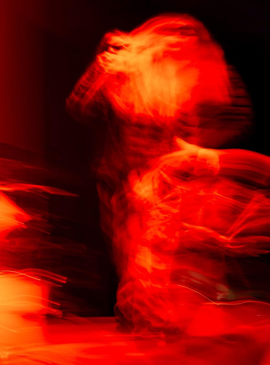 An abstract photo shows No Cure vocalist Blaythe Steuer performing on stage at Red Flag Concert Hall in St. Louis, Mo., on Nov. 1, 2025.
